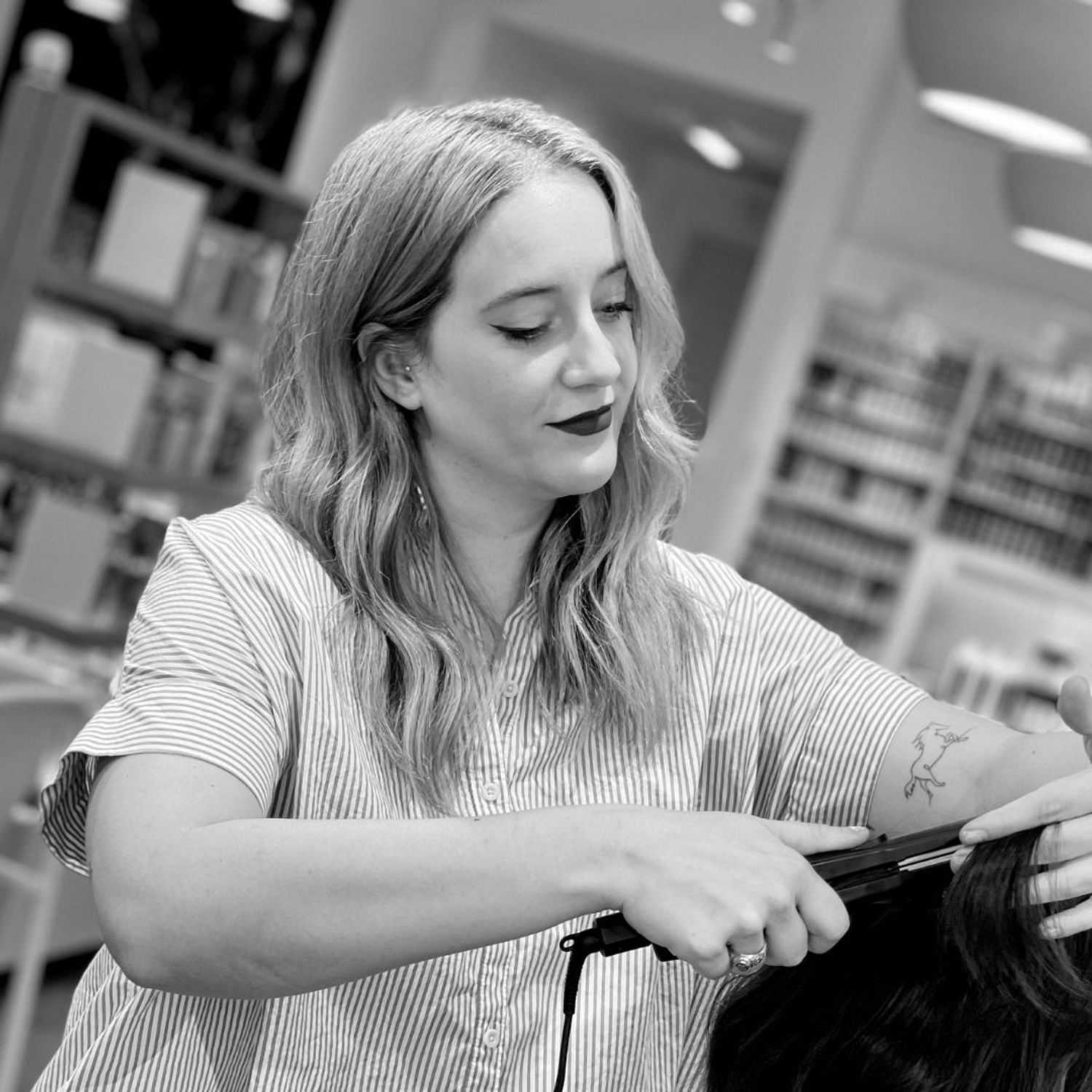 Portrait of Cassidy, a professional stylist at Hue Salon Houston, showcasing their expertise and style.