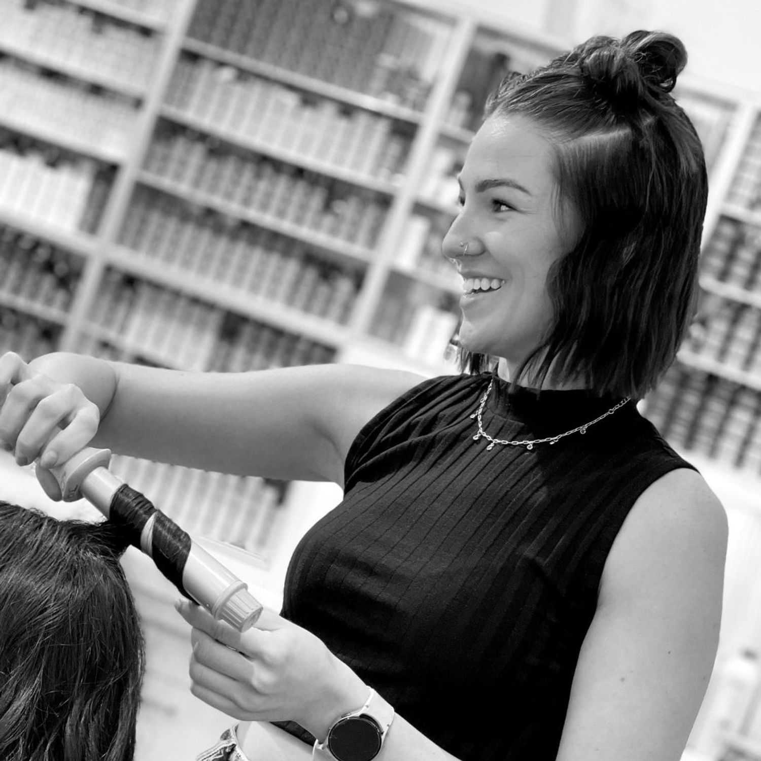 Portrait of Brittnie, a professional stylist at Hue Salon Houston, showcasing their expertise and style.