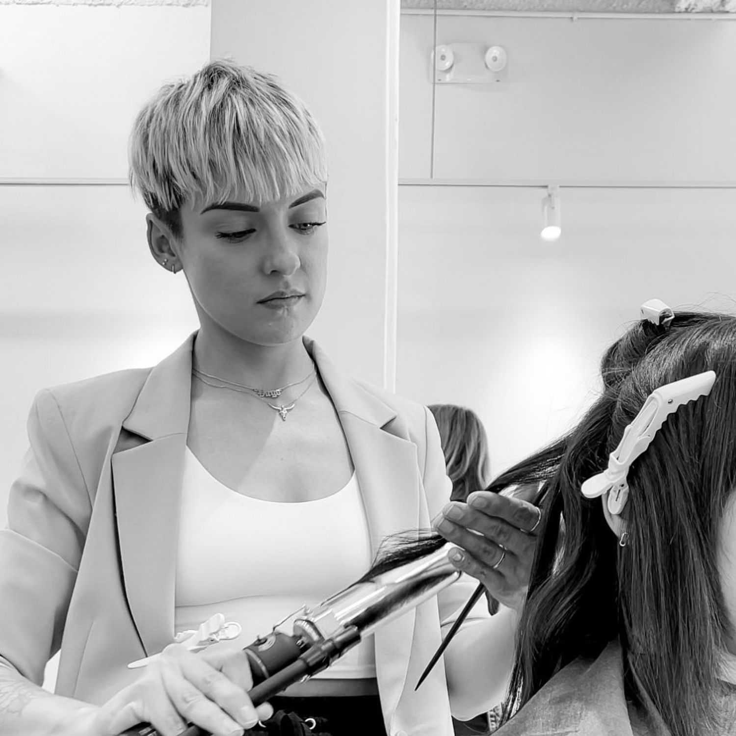 Portrait of Tess, a professional stylist at Hue Salon Houston, showcasing their expertise and style.