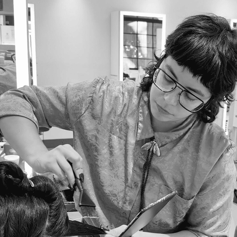 Portrait of Caro, a professional stylist at Hue Salon Houston, showcasing their expertise and style.