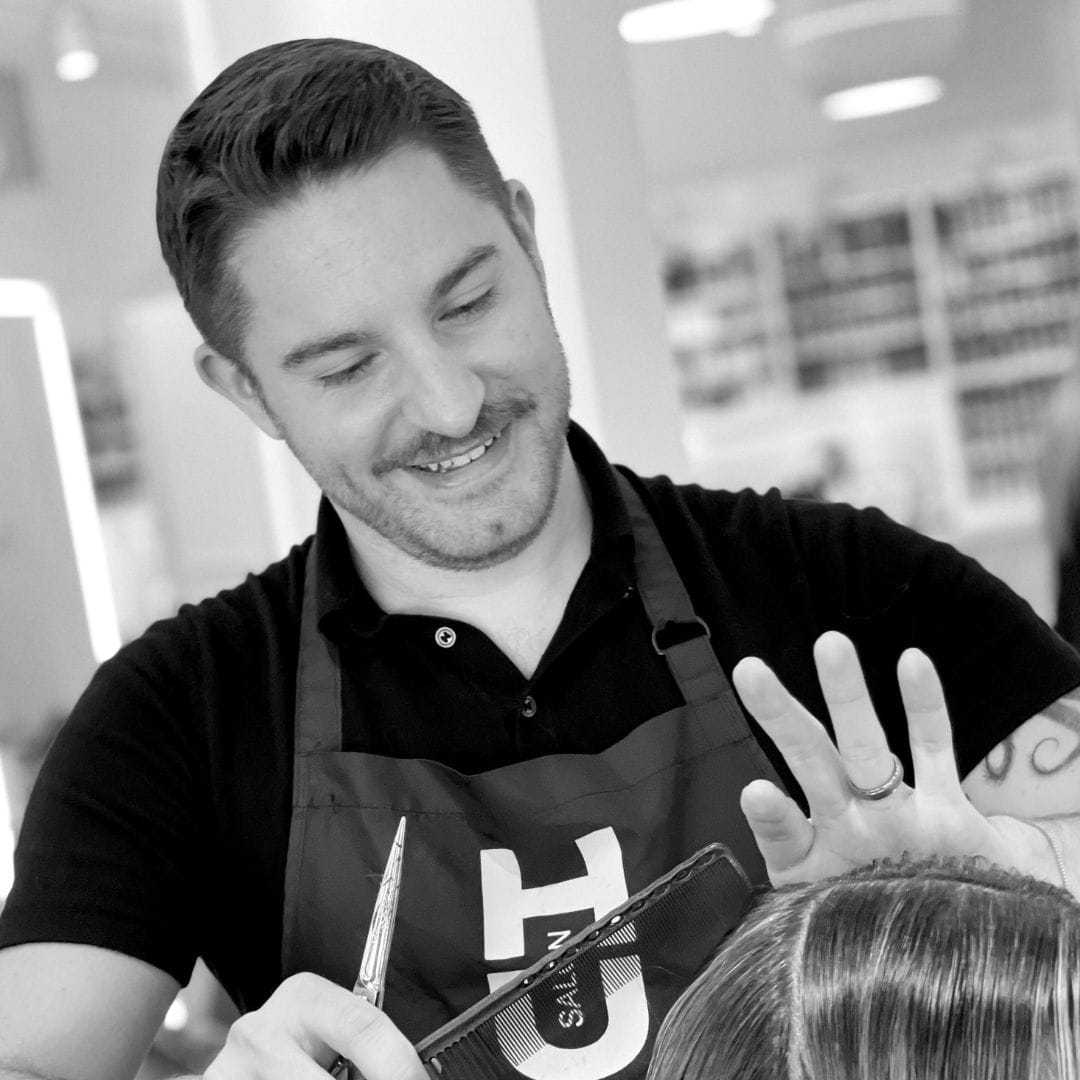 Portrait of Justin, a professional stylist at Hue Salon Houston, showcasing their expertise and style.