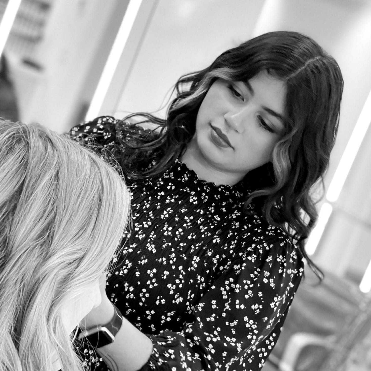 Portrait of Denisse, a professional stylist at Hue Salon Houston, showcasing their expertise and style.