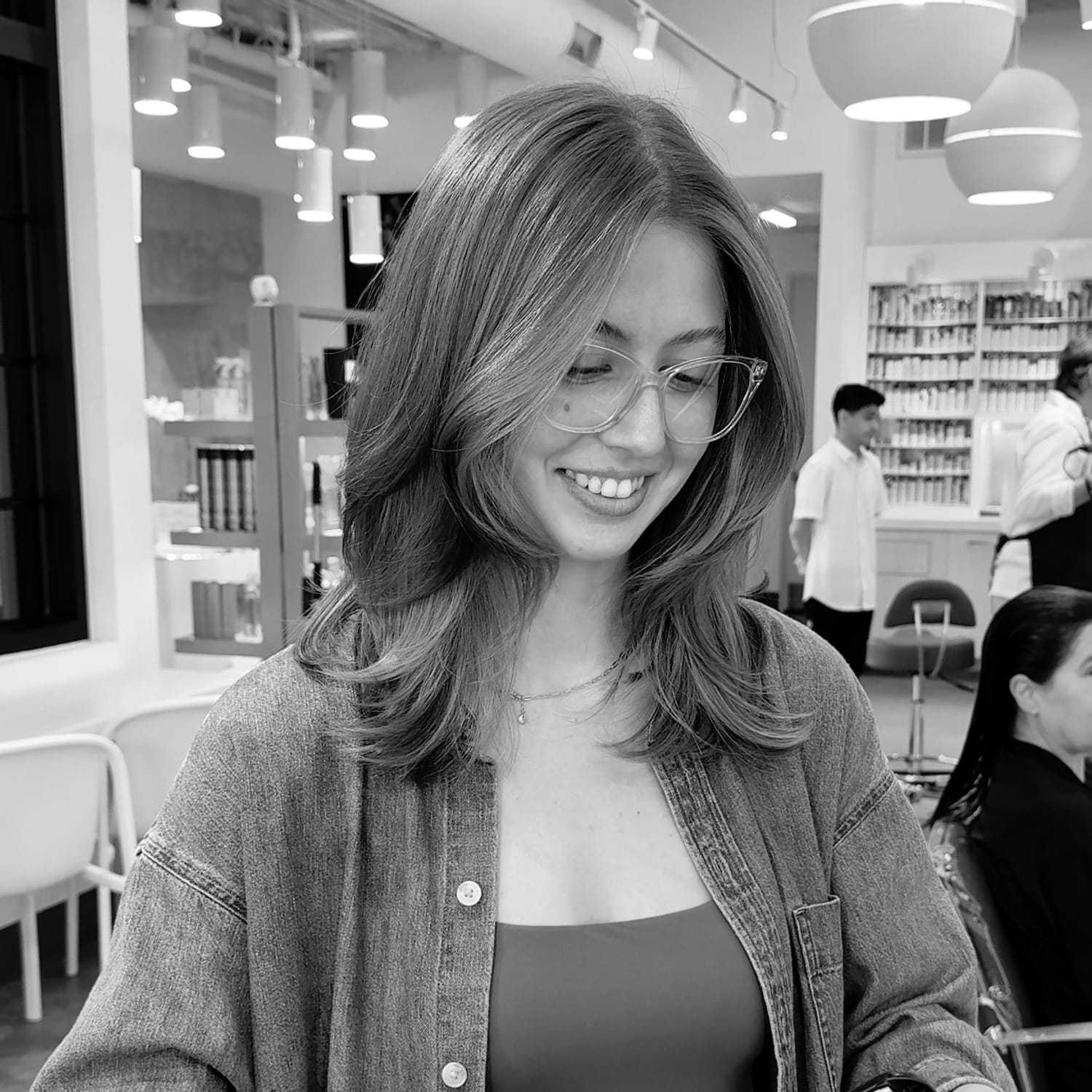 Portrait of Ashlynn, a professional stylist at Hue Salon Houston, showcasing their expertise and style.