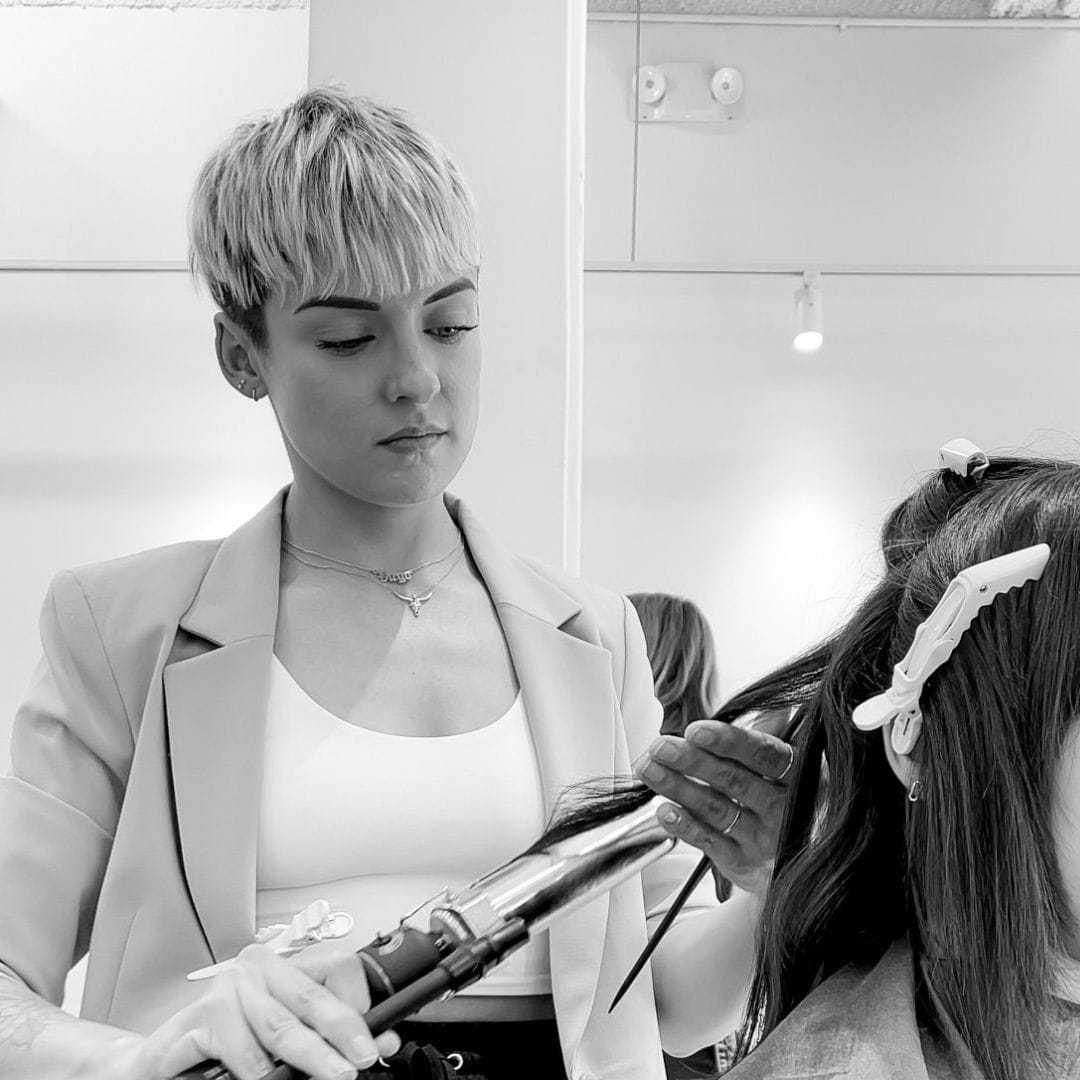 Portrait of Tess, a professional stylist at Hue Salon Houston, showcasing their expertise and style.
