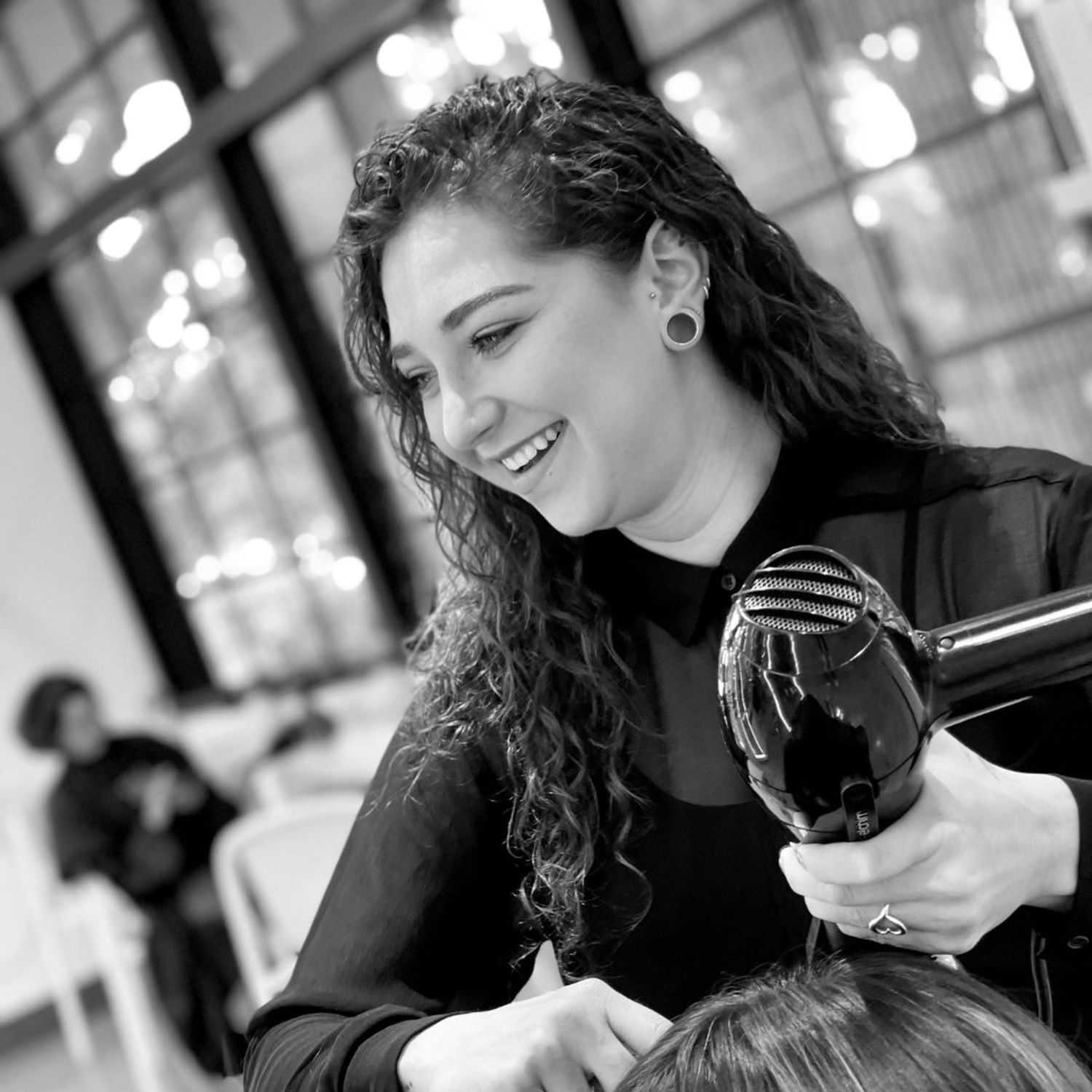 Portrait of Allegra, a professional stylist at Hue Salon Houston, showcasing their expertise and style.